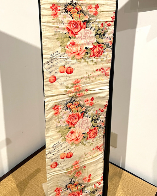 Traditional obi belt featuring a musical staff and rose motif