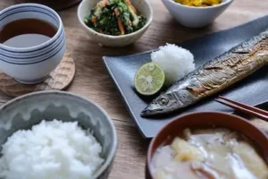 Delicious Japanese set meal with grilled Pacific saury, rice, miso soup, and seasonal side dishes.