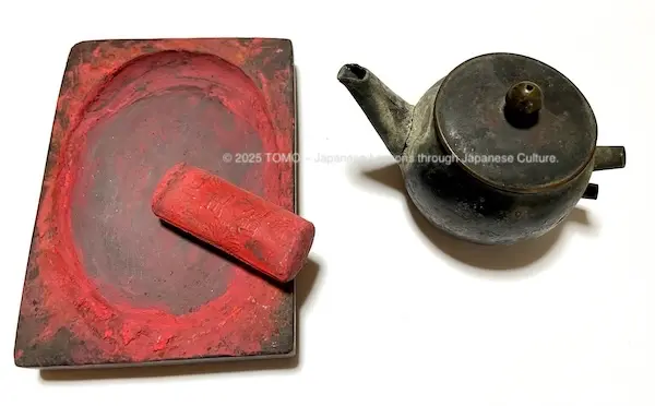 Traditional tools: Vermilion ink stick, inkstone, and water container
