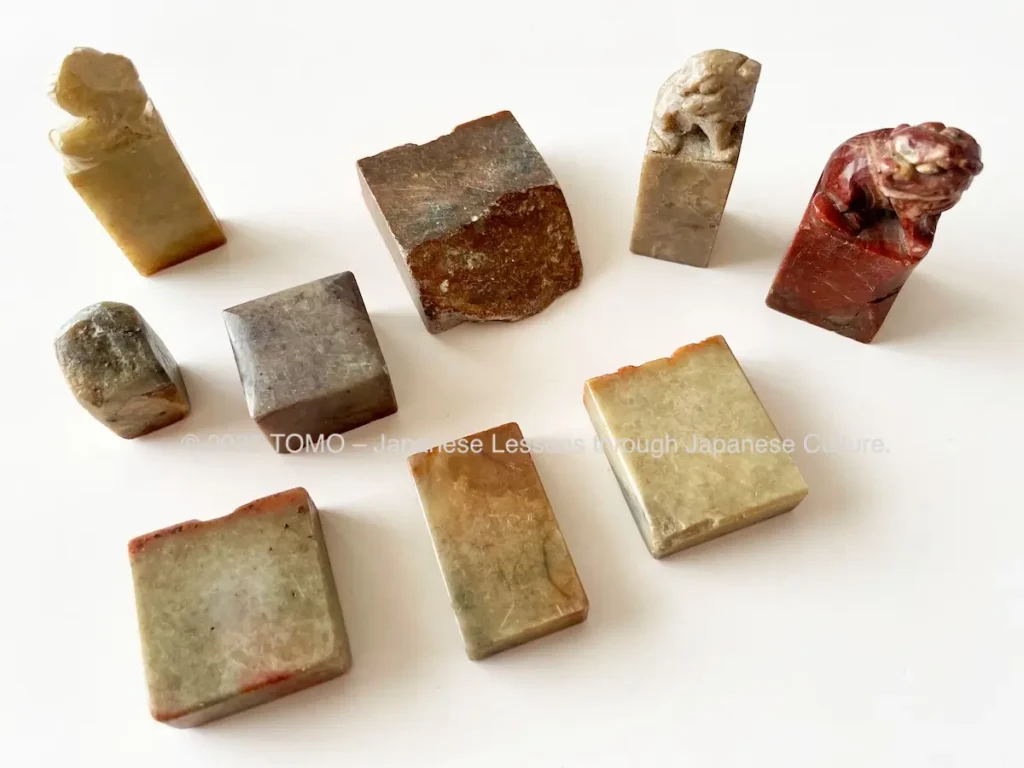 Stone Japanese seals (hanko) used in seal engraving, showing the natural patterns and various colors of the stone material.