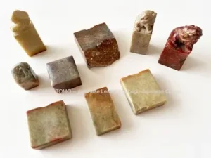 Various stone Japanese seals (hanko) for seal engraving, highlighting the unique colors and natural textures of each stone.